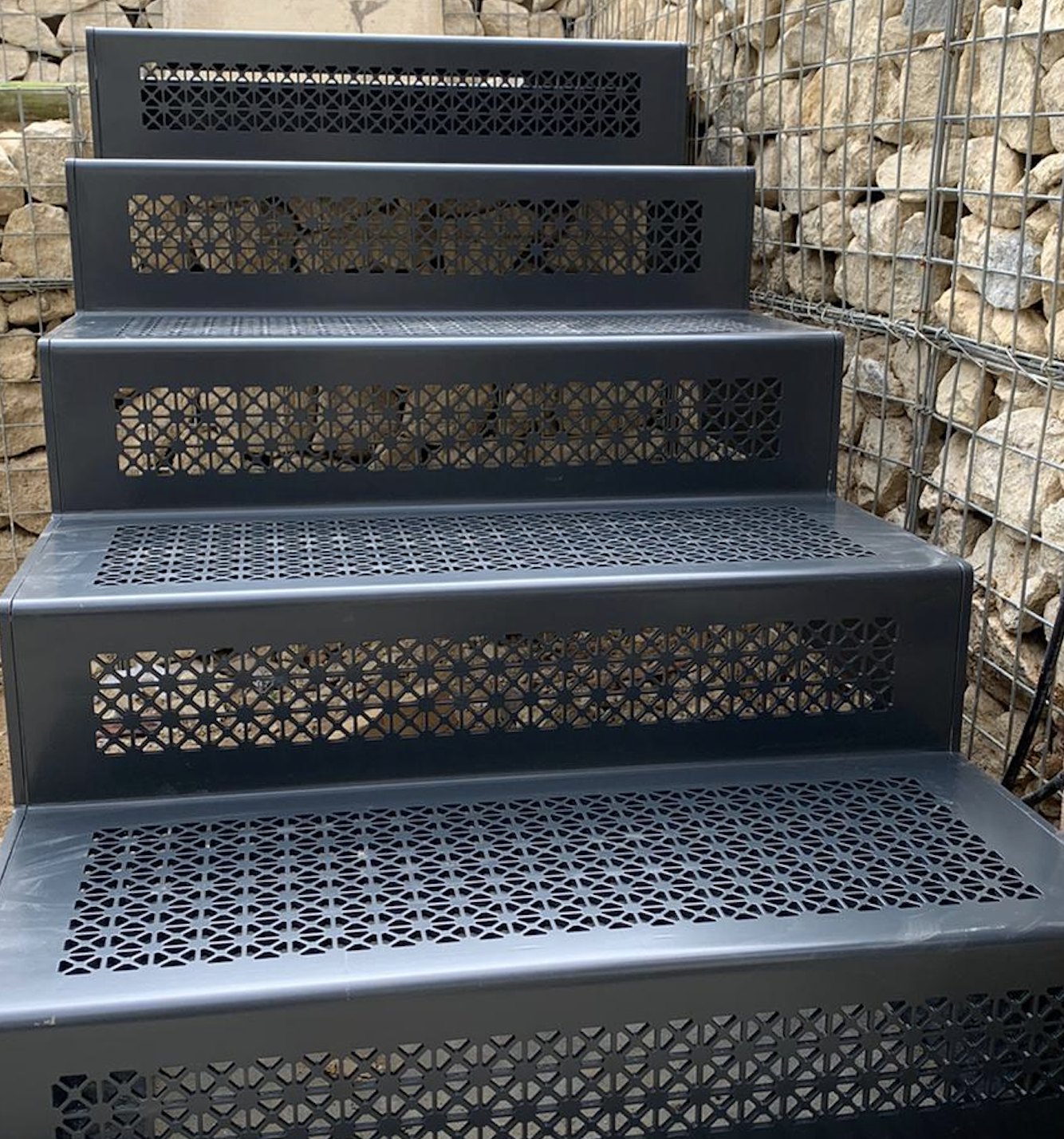 Garden steps between gabion walls: grey coated steel, patterned punched treads and risers