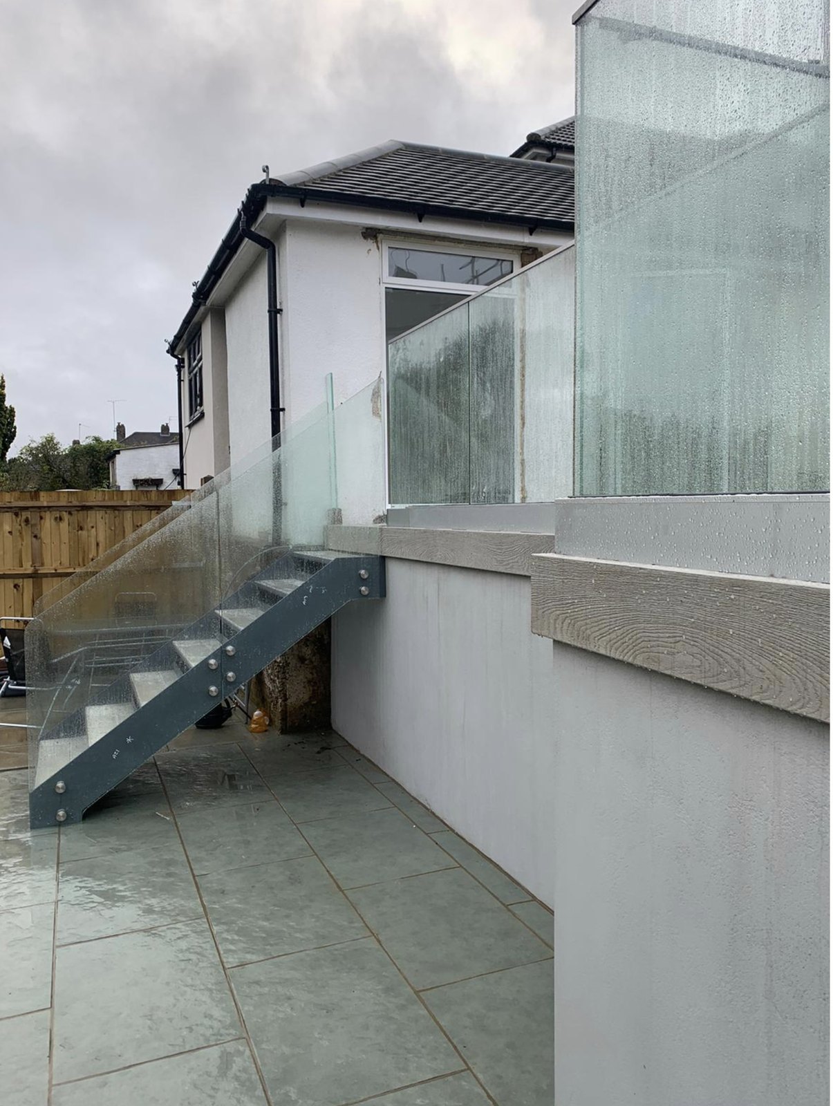 Patio to raised terrace: grey steel flight with clear glass sides